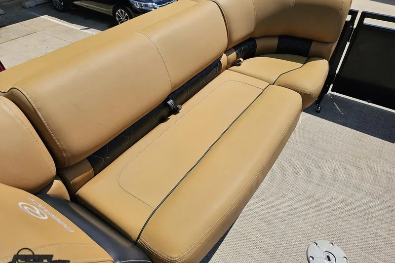 Slide: The Image of 2021 Regency 230 LE3 boat with tan leather seating and black accents. - 92