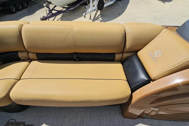 Slide: The Image of Luxurious tan seating on 2021 Regency 230 LE3 boat, showcasing comfort and style. - 95