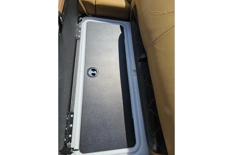 Slide: The Image of 2021 Regency 230 LE3 storage compartment with tan seating and secure latch. - 97