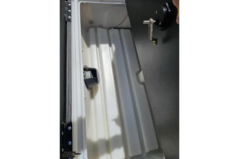 Slide: The Image of Open storage compartment of 2021 Regency 230 LE3 boat, showing interior details. - 98