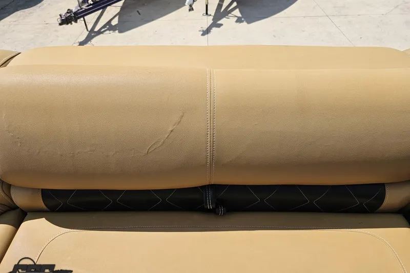Slide: The Image of Beige leather seat of 2021 Regency 230 LE3 boat, showing stitching details. - 99