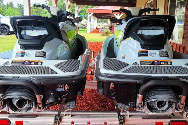 Slide: The Image of 2023 Kawasaki Jetski STX 160 models on a trailer, ready for adventure. - 2