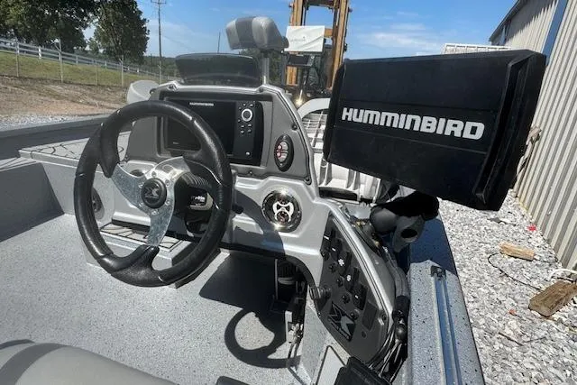 Slide: The Image of 2022 Xpress X19 Pro boat dashboard with steering wheel and Humminbird fish finder. - 11