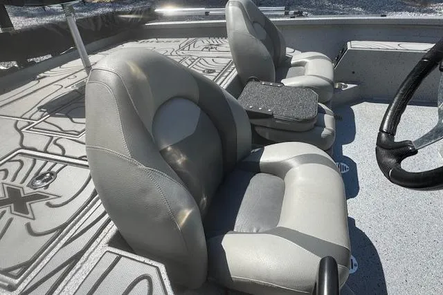 Slide: The Image of 2022 Xpress X19 Pro boat interior with gray cushioned seats and steering wheel. - 12