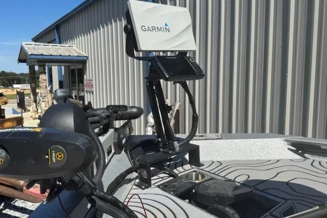 Slide: The Image of Garmin device on 2022 Xpress X19 Pro boat, near metal building. - 2