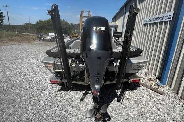 Slide: The Image of 2022 Xpress X19 Pro boat with 175 HP engine, parked on gravel near a metal building. - 9