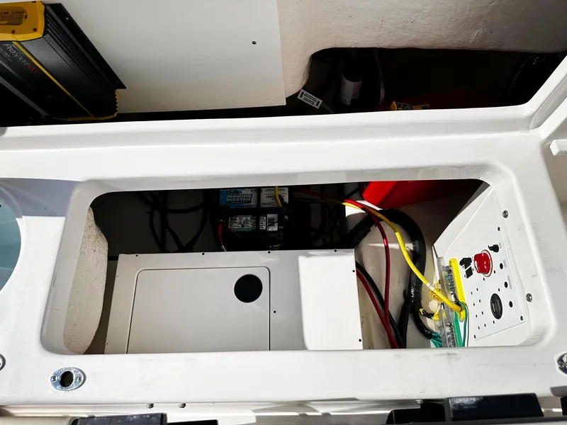 Slide: The Image of 2021 Robalo R222 Explorer boat interior showing electrical components and wiring. - 12