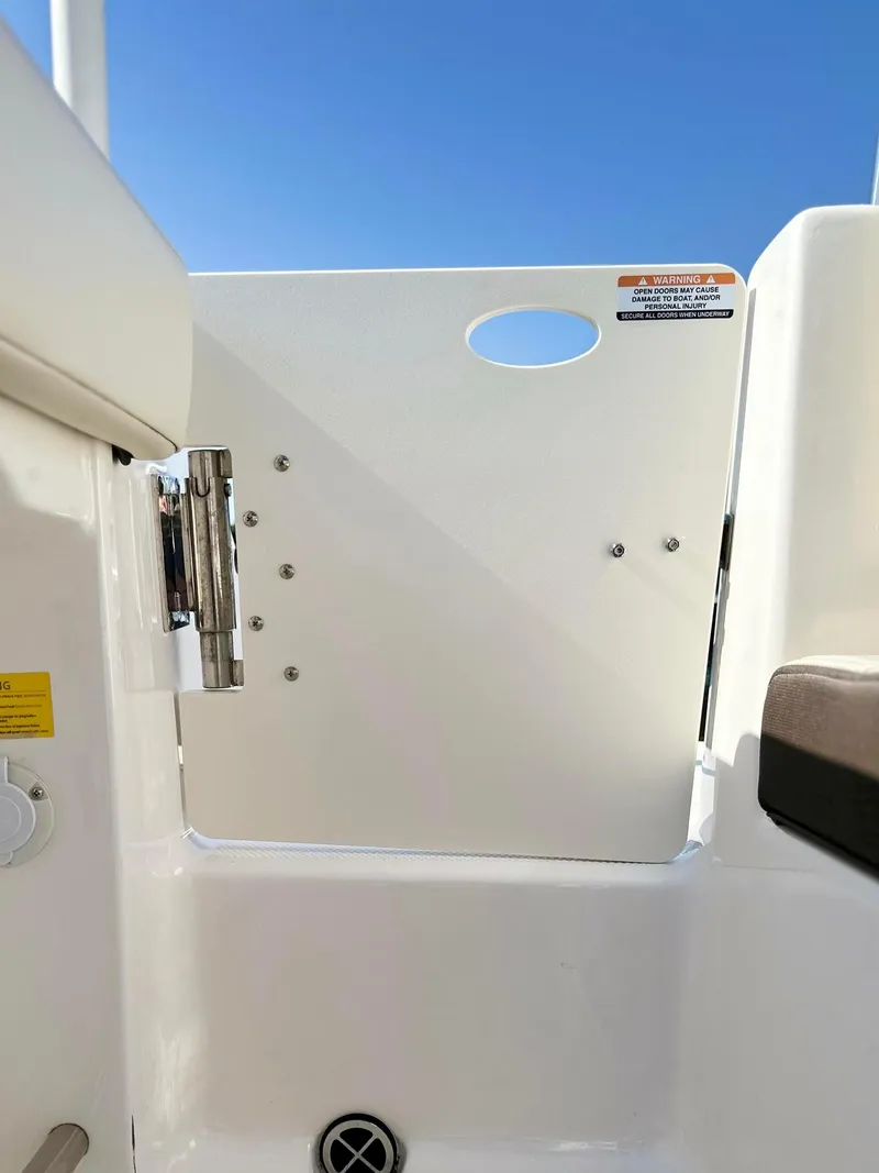 Slide: The Image of 2021 Robalo R222 Explorer boat interior detail with white panel and blue sky background. - 20