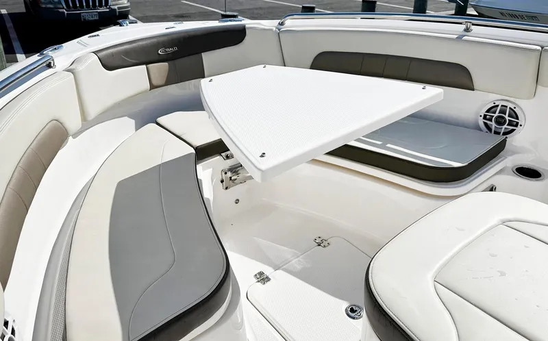 Slide: The Image of 2021 Robalo R222 Explorer boat interior with seating and table setup. - 23