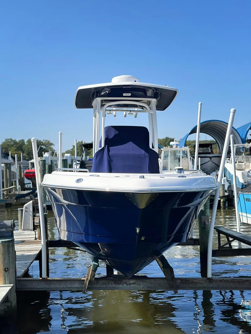 Slide: The Image of 2021 Robalo R222 Explorer boat docked at marina, front view. - 26