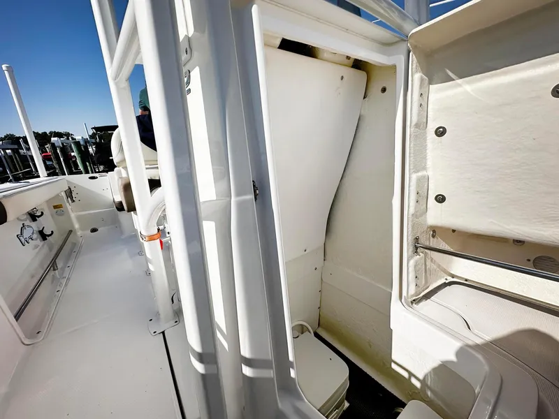 Slide: The Image of 2021 Robalo R222 Explorer boat interior, showcasing storage compartments and seating area. - 3