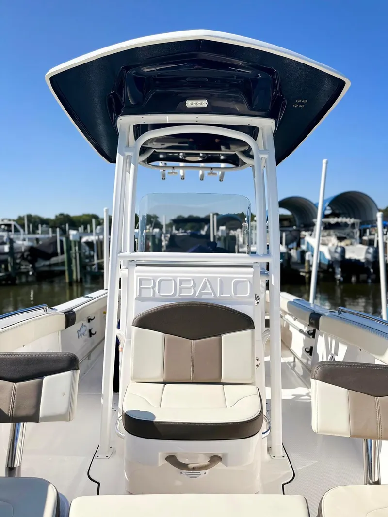 Slide: The Image of 2021 Robalo R222 Explorer boat with seating, docked at marina. - 8