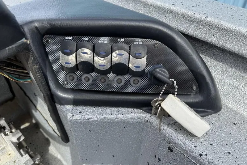 Slide: The Image of Control panel of 2016 Xpress XCLUSIVE SERIES X21 boat with ignition key and switches. - 11