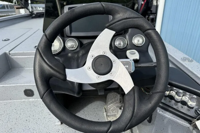 Slide: The Image of Steering wheel of 2016 Xpress XCLUSIVE SERIES X21 boat with dashboard controls. - 14
