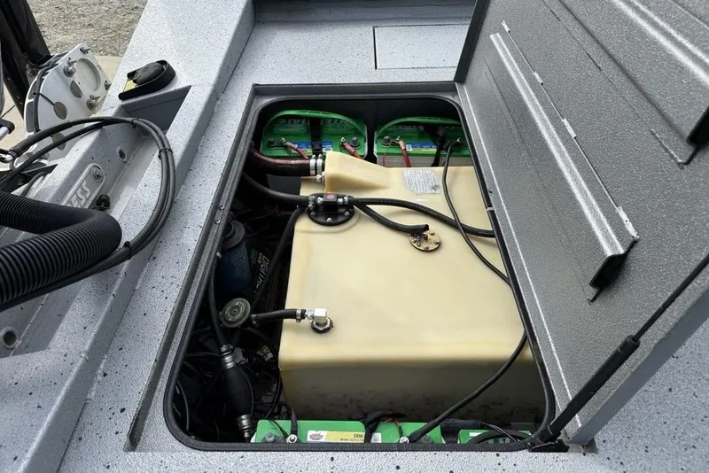 Slide: The Image of Open compartment of 2016 Xpress XCLUSIVE SERIES X21 boat showing battery and fuel tank. - 15