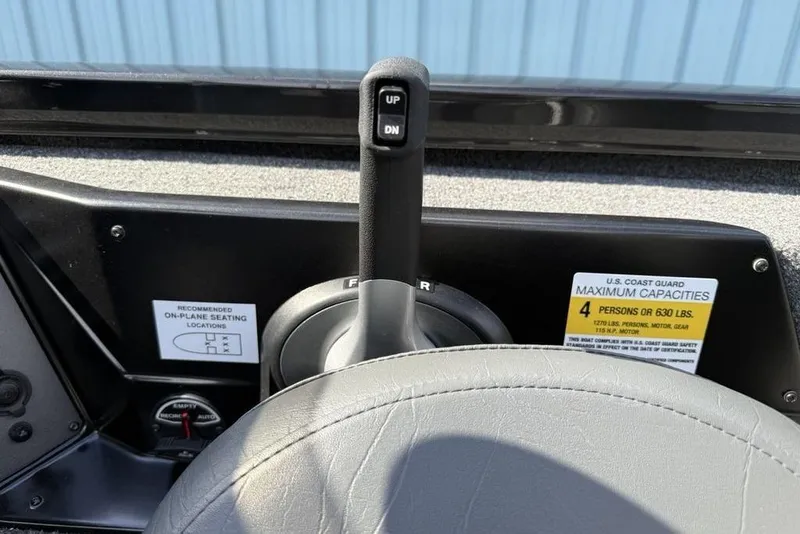 Slide: The Image of 2023 Vexus AVX189 boat control panel with capacity label and throttle lever. - 16