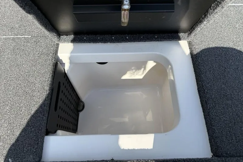 Slide: The Image of 2023 Vexus AVX189 boat storage compartment with carpeted interior and drainage feature. - 18