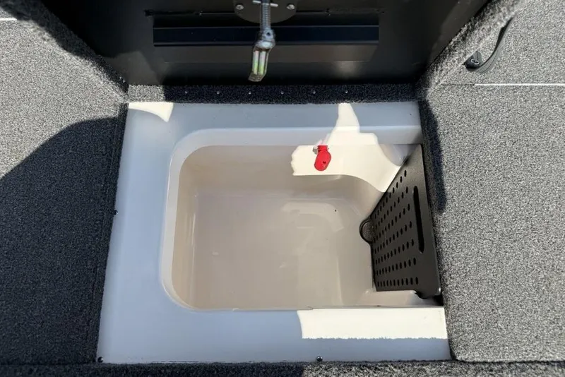 Slide: The Image of 2023 Vexus AVX189 boat storage compartment with carpeted interior and drainage system. - 19