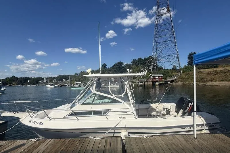 Slide: The Image of 1995 Grady-White Gulfstream 232 boat docked by a scenic waterfront. - 10