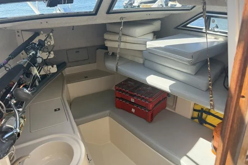 Slide: The Image of Interior of a 1995 Grady-White Gulfstream 232 boat with fishing rods and cushions. - 8