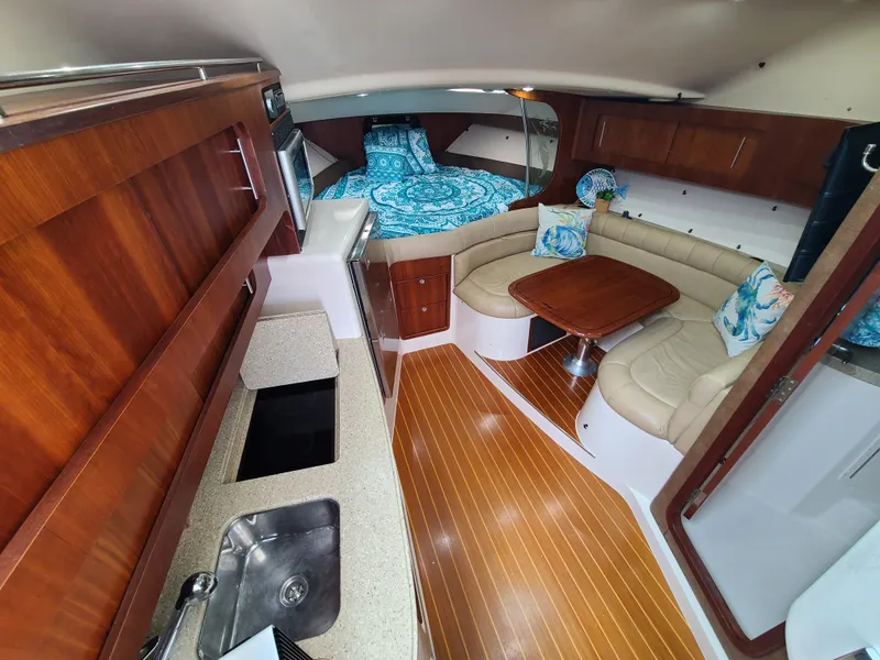 Slide: The Image of Luxurious 2011 Grady-White Express 360 cabin with wood finishes and cozy seating area. - 15