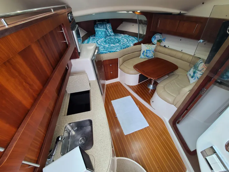 Slide: The Image of Luxurious 2011 Grady-White Express 360 cabin interior with wood finishes and cozy seating area. - 16