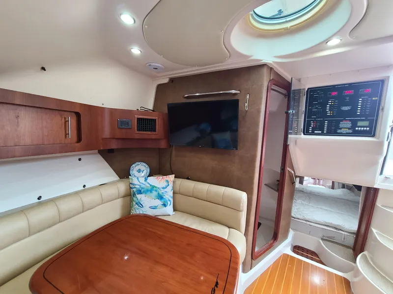 Slide: The Image of Interior of 2011 Grady-White Express 360 boat with seating, table, and control panel. - 17