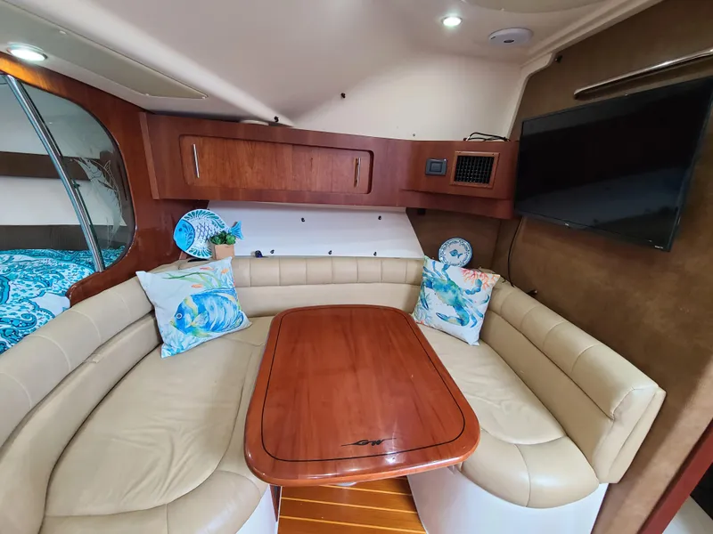 Slide: The Image of Interior of 2011 Grady-White Express 360 with leather seating and wooden table. - 19