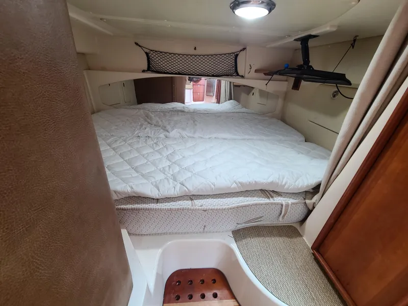 Slide: The Image of 2011 Grady-White Express 360 cabin interior with bed and storage. - 28