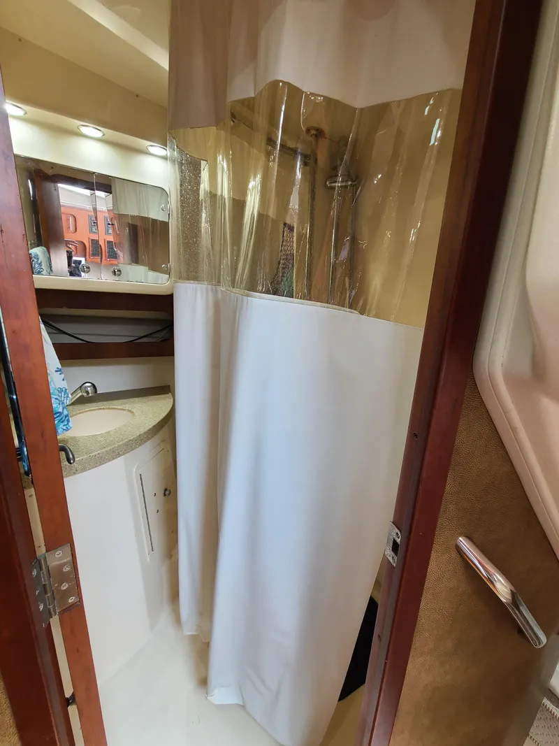 Slide: The Image of 2011 Grady-White Express 360 bathroom with shower curtain and vanity. - 29