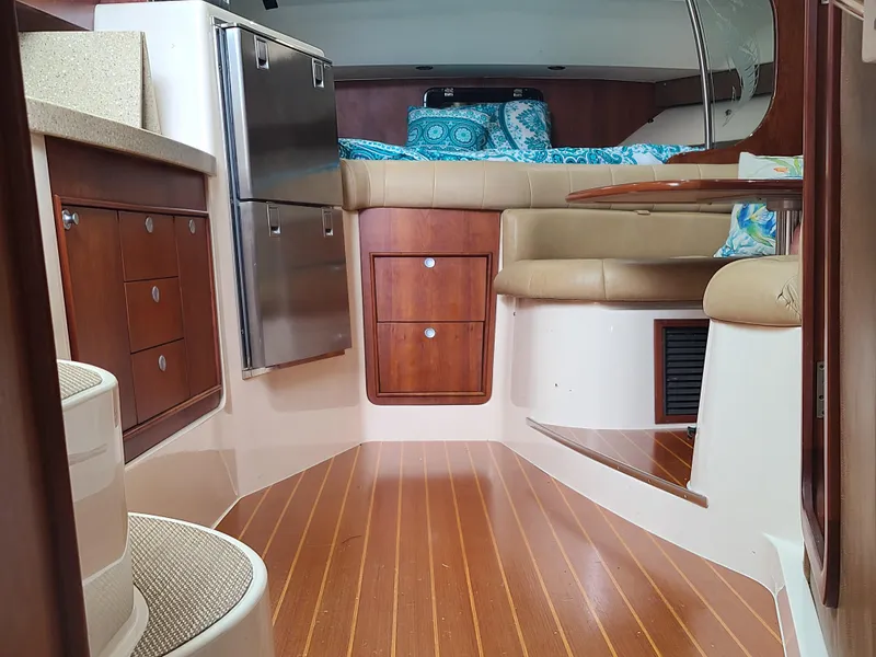 Slide: The Image of Interior of 2011 Grady-White Express 360 boat with wood flooring and cozy seating area. - 30