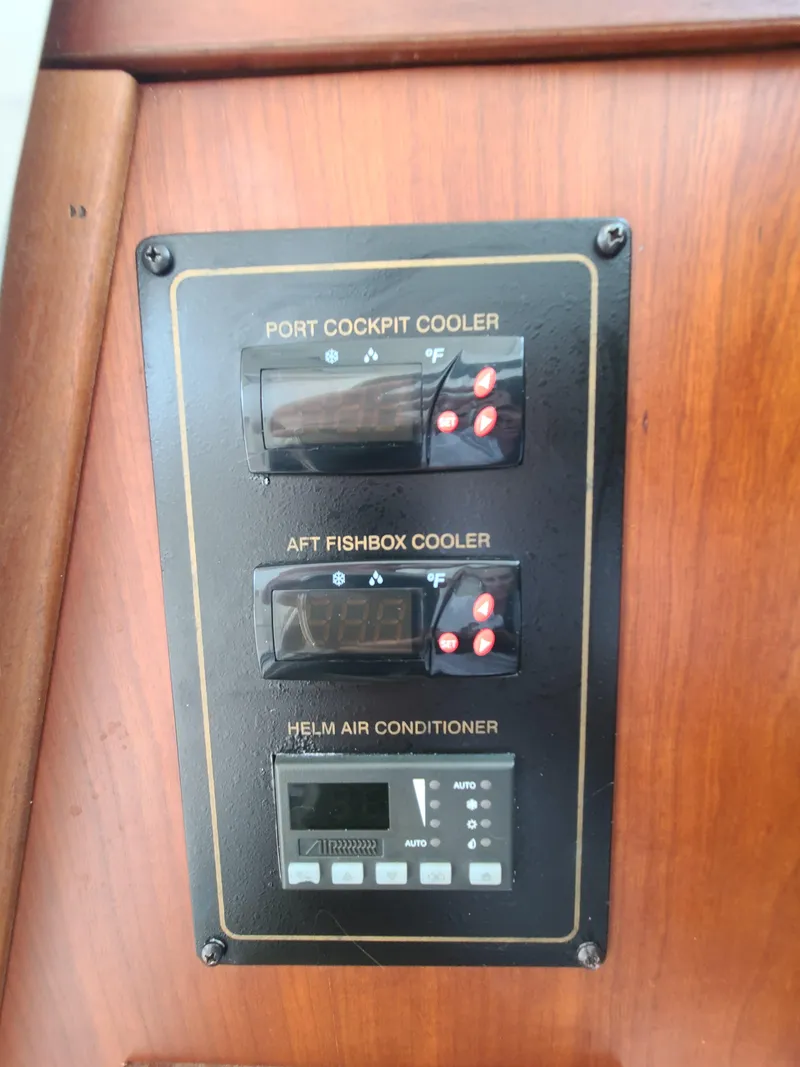 Slide: The Image of Control panel on 2011 Grady-White Express 360 for coolers and air conditioner. - 32
