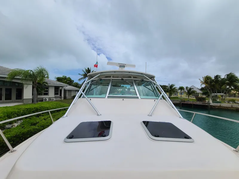 Slide: The Image of 2011 Grady-White Express 360 boat docked near tropical waterfront homes. - 34