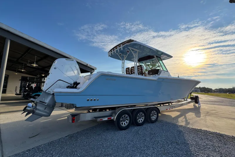 Slide: The Image of 2026 Bertram 34CC boat on trailer at sunset, showcasing sleek design and powerful engines. - 12