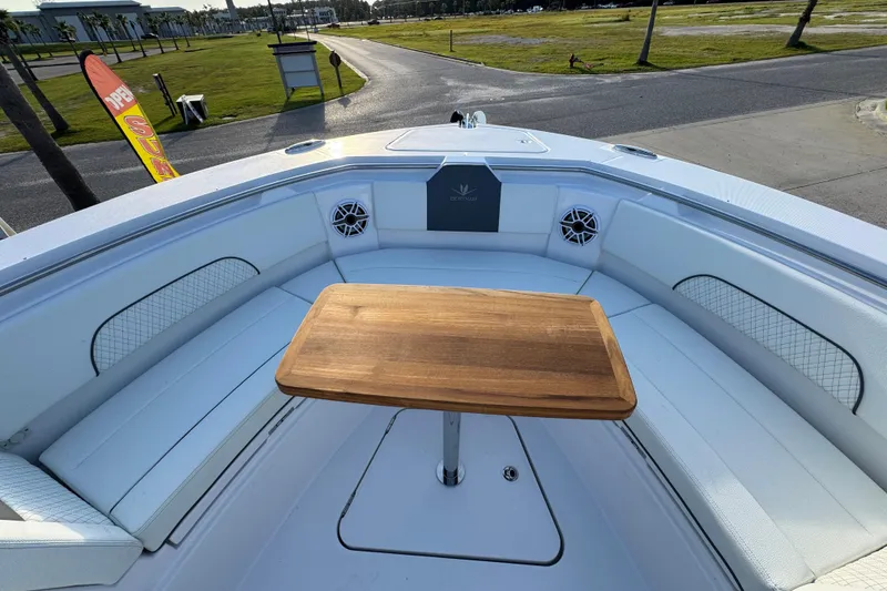 Slide: The Image of 2026 Bertram 34CC boat interior with wooden table and cushioned seating. - 14