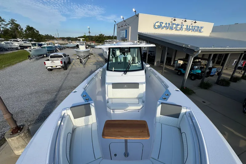 Slide: The Image of 2026 Bertram 34CC boat at Grander Marine dealership, showcasing sleek design and spacious seating. - 16