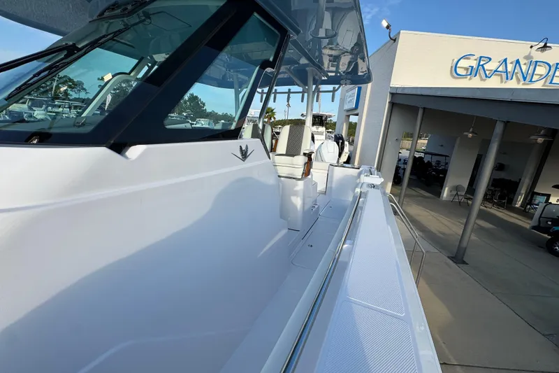 Slide: The Image of 2026 Bertram 34CC boat at dealership, showcasing sleek design and modern features. - 18