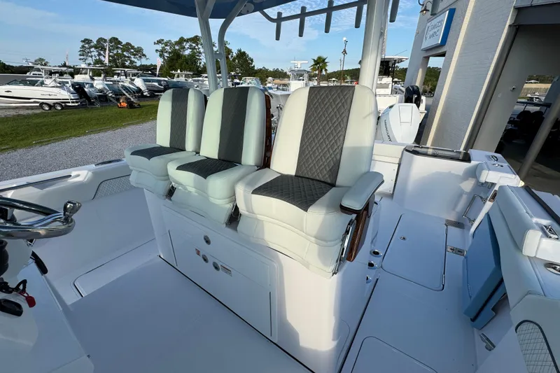 Slide: The Image of 2026 Bertram 34CC boat interior with three cushioned seats and steering wheel. - 20