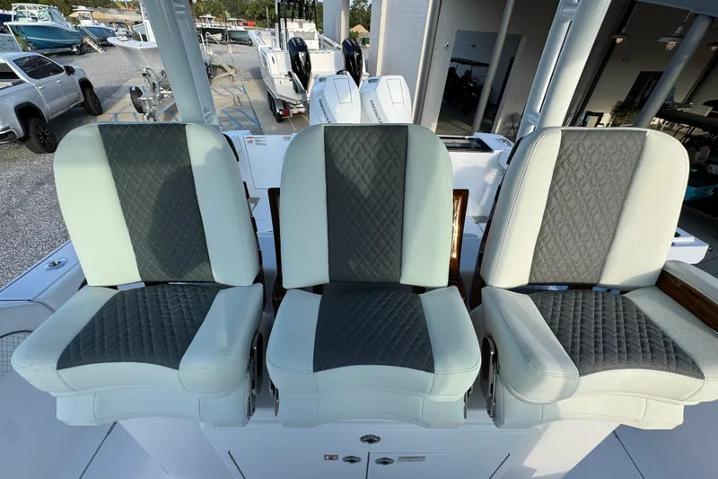 Slide: The Image of Three cushioned seats on a 2026 Bertram 34CC boat, featuring diamond-patterned upholstery. - 21