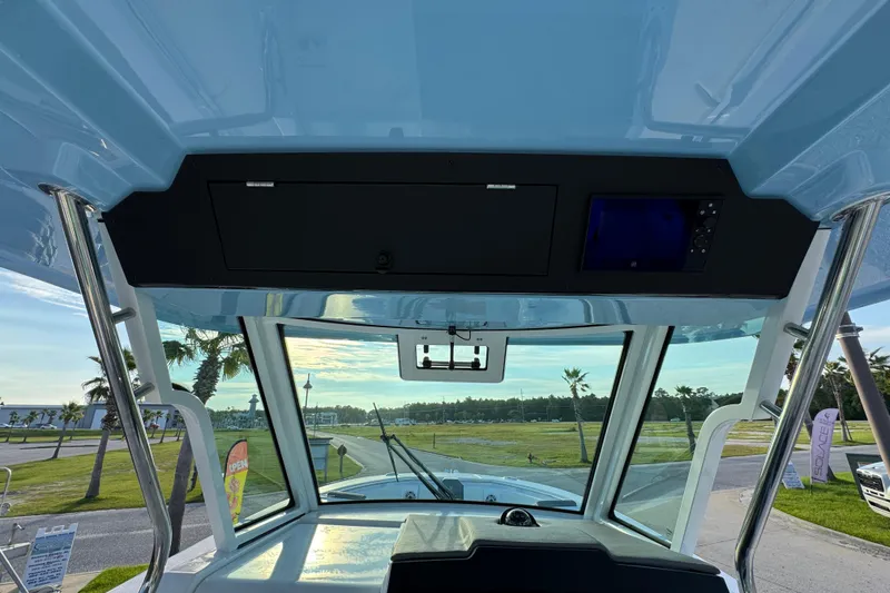 Slide: The Image of Interior view of 2026 Bertram 34CC boat cockpit with scenic outdoor background. - 25