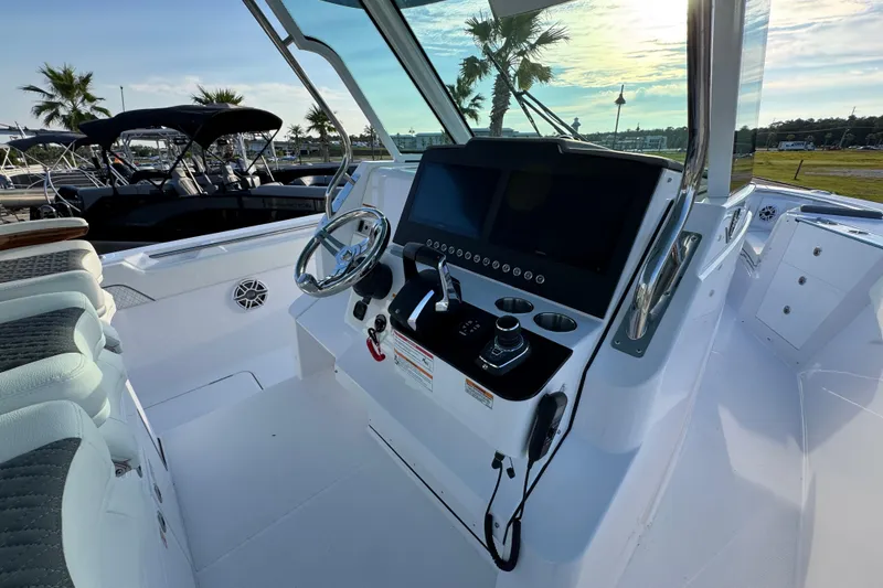 Slide: The Image of 2026 Bertram 34CC boat cockpit with modern steering and control panel. - 26