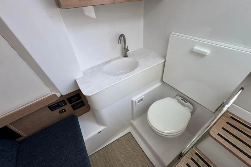 Slide: The Image of 2026 Bertram 34CC boat interior with compact bathroom, sink, and toilet. - 28