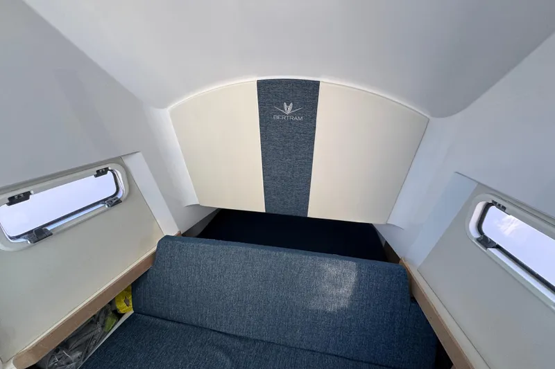 Slide: The Image of Interior cabin of 2026 Bertram 34CC boat with blue and white upholstery. - 30