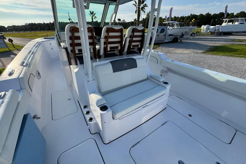 Slide: The Image of 2026 Bertram 34CC boat interior with seating and cup holders, parked outdoors. - 31