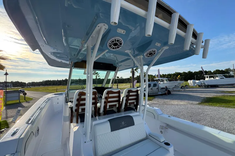 Slide: The Image of 2026 Bertram 34CC boat interior with seating and rod holders, parked outdoors. - 32