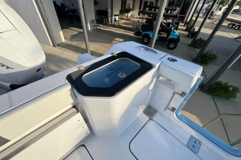 Slide: The Image of 2026 Bertram 34CC boat deck with storage compartment and seating area. - 35