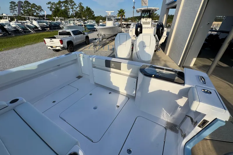 Slide: The Image of 2026 Bertram 34CC boat interior with dual engines, parked at a marina. - 36