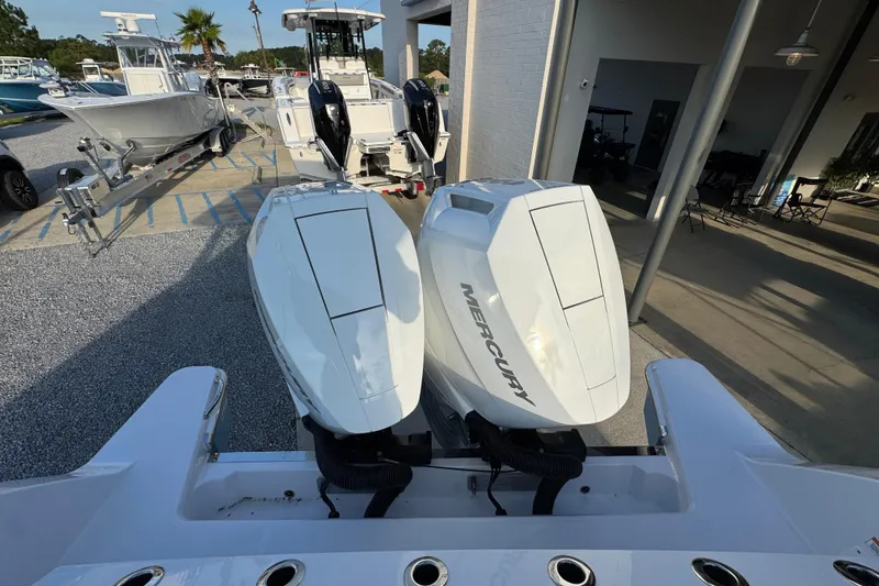 Slide: The Image of 2026 Bertram 34CC boat with twin Mercury outboard engines in a marina setting. - 38