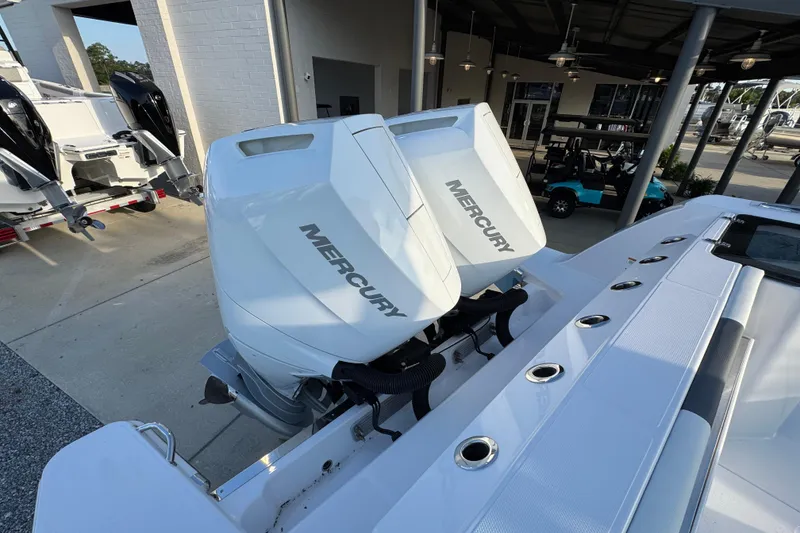 Slide: The Image of 2026 Bertram 34CC boat with dual Mercury outboard engines in a showroom. - 39