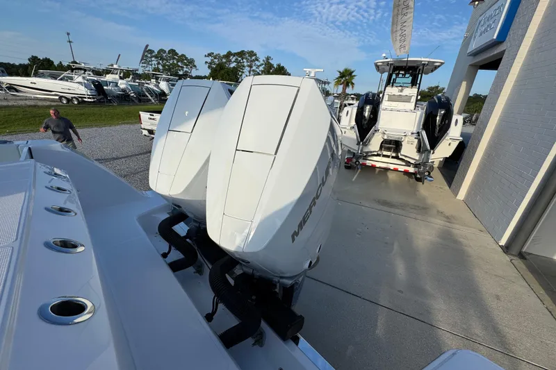 Slide: The Image of 2026 Bertram 34CC boat with dual Mercury outboard engines at a marina. - 40